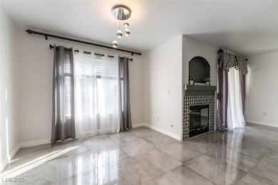 Unfurnished living room featuring baseboards and a