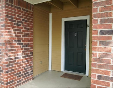 Entrance to property featuring brick siding