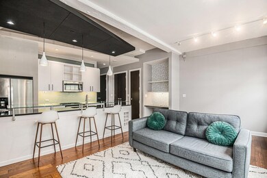 Living room with wood-type flooring and track ligh