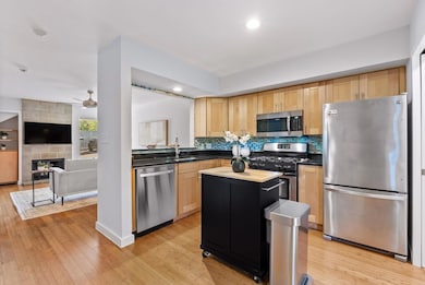 Kitchen featuring backsplash, light wood-style fl