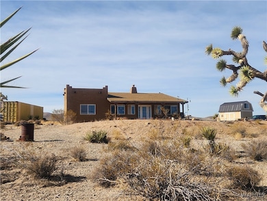 Rear view of property with a storage shed