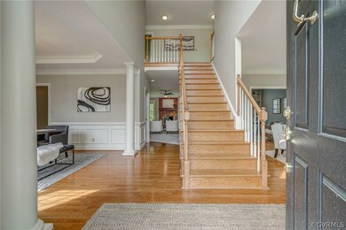 Two-story entryway featuring a stunning chasndelie