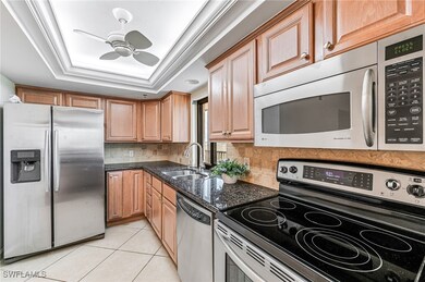 Kitchen with light tile patterned floors, stainles