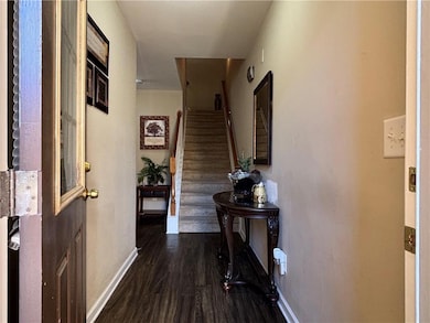 Corridor with dark wood-style floors and stairway