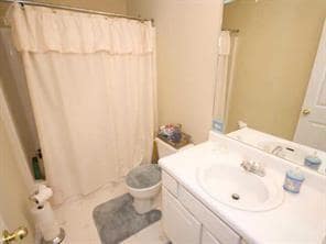 Full bath featuring vanity, toilet, and tile patterned floors