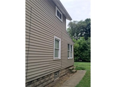New windows and newer siding. Glass block in the b