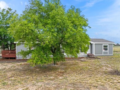 Front view showing mature trees