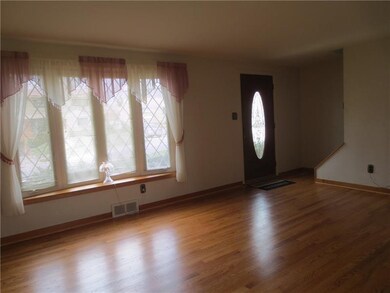 Living room boasts of gorgeous hardwood floors and