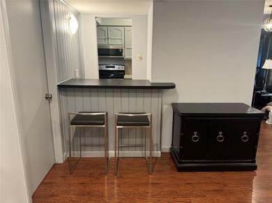 Kitchen with stove, kitchen peninsula, and dark ha