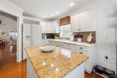Kitchen featuring white cabinetry wood flooring, d
