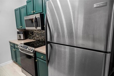 Kitchen featuring stainless steel appliances, ligh