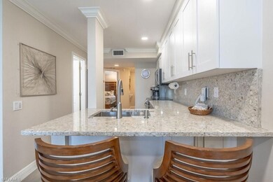 Kitchen featuring white cabinets, a peninsula, cro