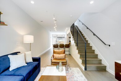 Living area featuring baseboards, stairs, light w