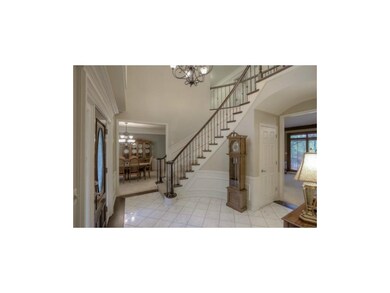 WINDING CURVED STAIRCASE WITH IRON SPINDLES. DININ