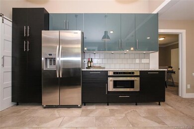 Kitchen area boasts full size pantry beside the st
