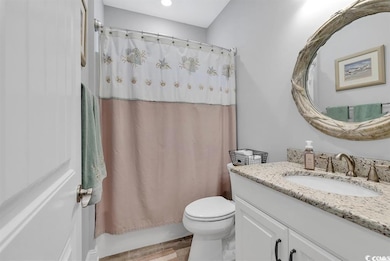 Bathroom featuring vanity and toilet