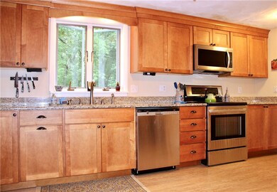 Beautifully redone kitchen features maple cabinets