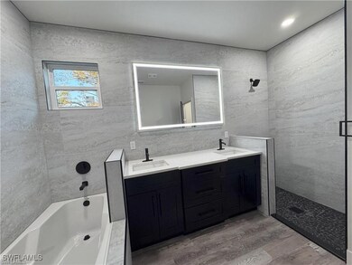 Bathroom featuring a shower, a bath, double vanity