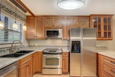 Beadboard custom wood cabinets w/ tile backsplash