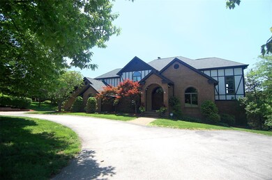 Gracious covered entrance, driveway with extra parking, four car garage, very custom home!