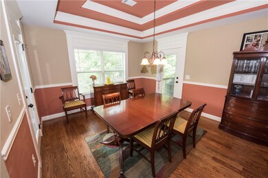 Dining Room with double tray ceiling and chair rai
