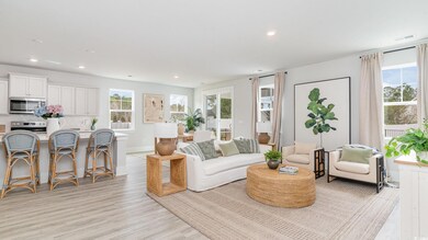 Living area featuring healthy amount of natural light, recessed lighting, light wood-type flooring, and baseboards