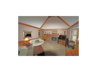 Living room with vaulted ceiling, bay window, fire