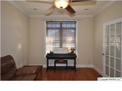 FRENCH DOORS OPEN INTO THE SEPARATE LIVING ROOM AREA WHICH CAN ALSO SERVE AS THE PERFECT OFFICE OR STUDY. GLEAMING HARDWOODS FLOORS AND CROWN MOULDING ARE FEATURED IN TIS ROOM, ALONG WITH A CEILING FAN.