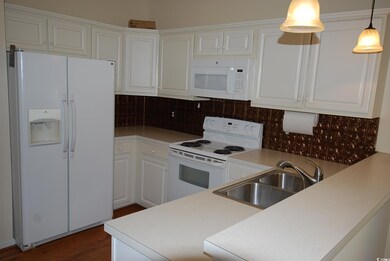 Kitchen featuring sink, tasteful backsplash, decor