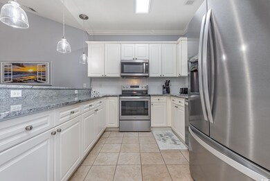 Kitchen with pendant lighting, appliances with sta