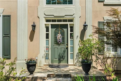 Doorway to property featuring stucco siding