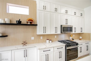 Kitchen featuring gas stove, stainless steel micro