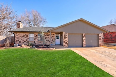 Ranch-style house with fence, a garage, a front ya