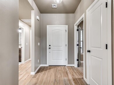 Entrance foyer with light hardwood / wood-style fl