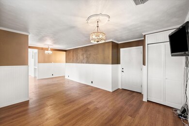 Living room leads into dining and kitchen area.