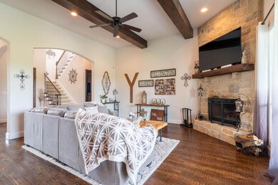 Gorgeous wood beams perfectly accent the mantle!