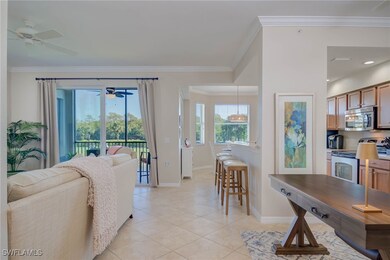 Living area featuring crown molding, a ceiling fan, baseboards, and light tile patterned floors