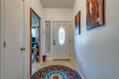 Foyer entrance with light tile patterned floors