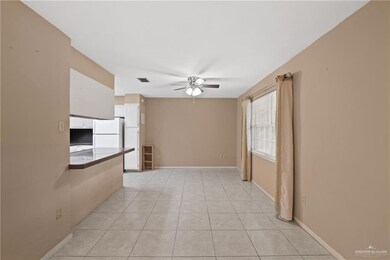 Unfurnished room featuring a ceiling fan, baseboards, visible vents, and light tile patterned floors