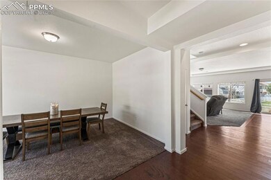 Dining area with baseboards, stairs, and wood fini