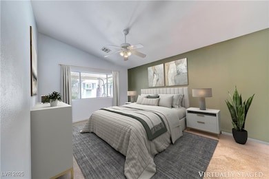 Bedroom featuring carpet, vaulted ceiling, and a c