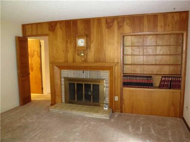 Living Room woodburning fireplace with gas log ins