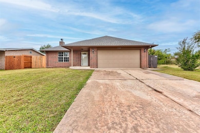 Single story home featuring driveway, brick siding, a gate, and a chimney