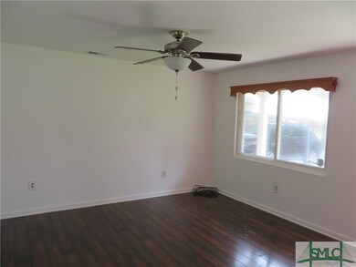 Living room shown empty (with large window)