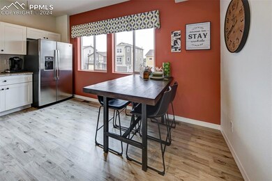 Dining space with light hardwood / wood-style floo