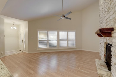 Unfurnished living room with ceiling fan, a stone