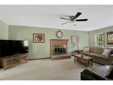 Large family room with brick fireplace, ceiling fa