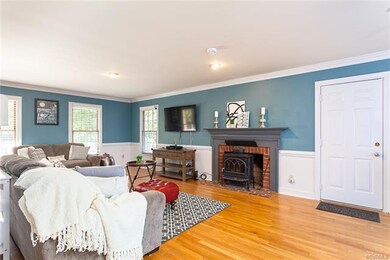 Spacious family room with gorgeous fireplace and mantle. Wood burning stove is included! Door leads to two car garage.