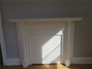 The Original Woodwork Makes  the Fireplace Quite C