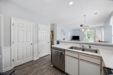 Kitchen with white cabinets, sink, stainless steel